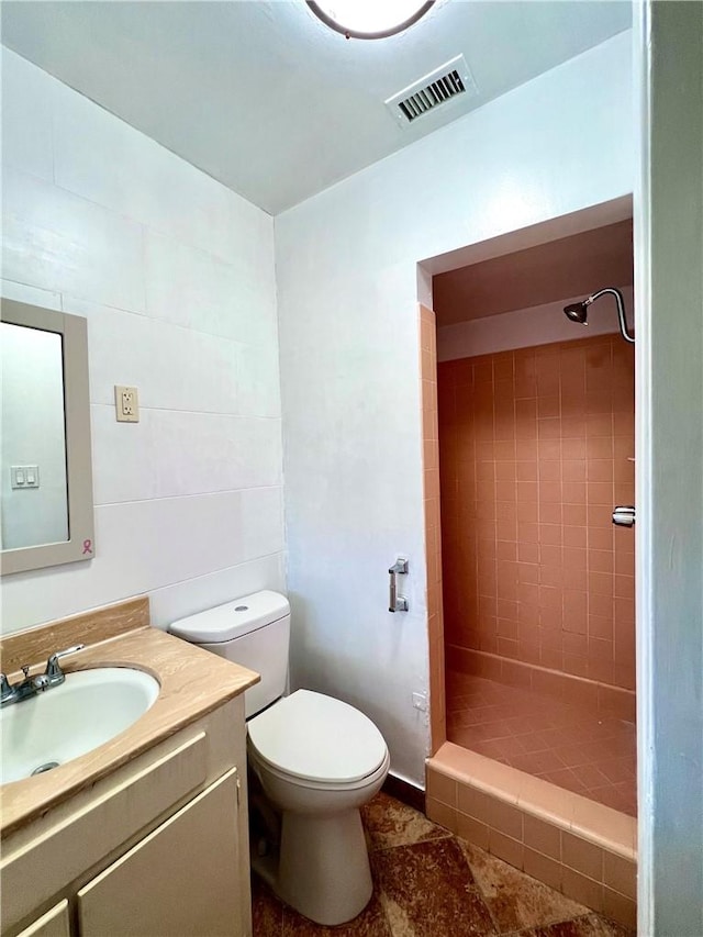 full bath with visible vents, toilet, a stall shower, and vanity