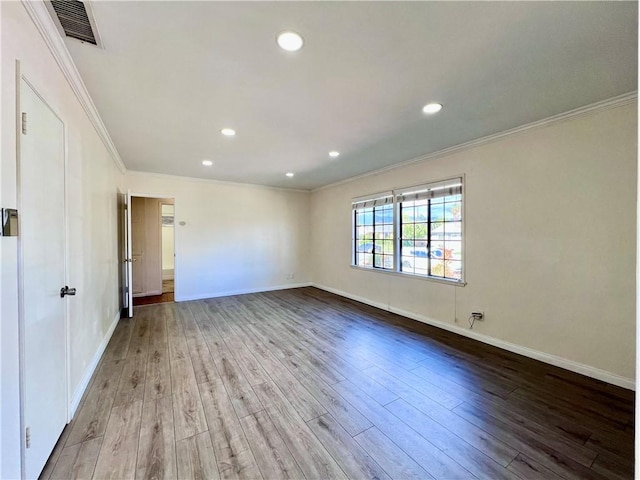 spare room with recessed lighting, visible vents, ornamental molding, and wood finished floors