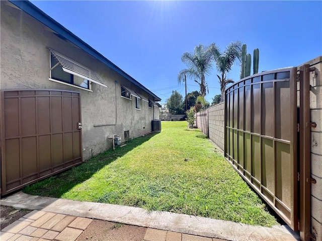 view of yard featuring central air condition unit and fence