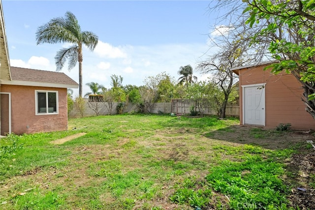 view of yard featuring an outbuilding and a fenced backyard