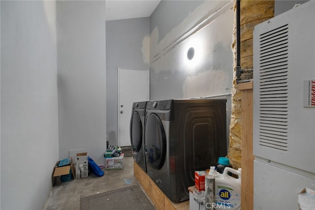 laundry room featuring heating unit, laundry area, and washing machine and clothes dryer