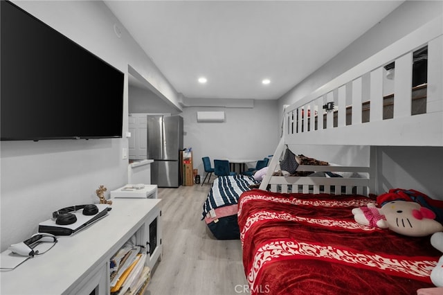 bedroom featuring recessed lighting, light wood-style flooring, and freestanding refrigerator