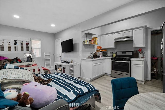 bedroom with recessed lighting and light wood-type flooring