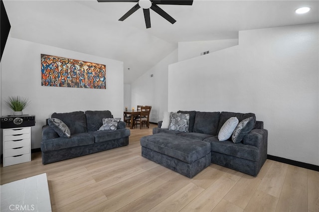 living room with visible vents, baseboards, light wood finished floors, lofted ceiling, and ceiling fan