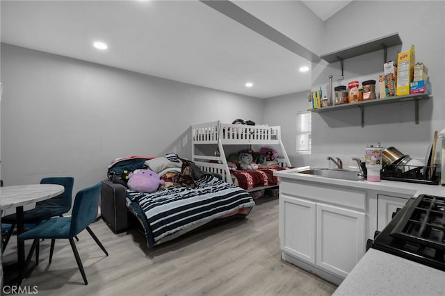 bedroom with a sink, light wood-style flooring, and recessed lighting