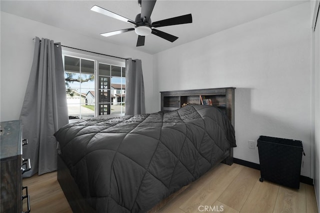 bedroom featuring light wood finished floors, baseboards, and ceiling fan