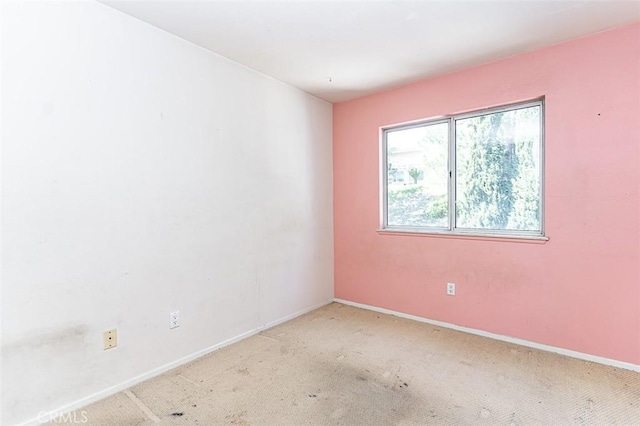 carpeted spare room with baseboards