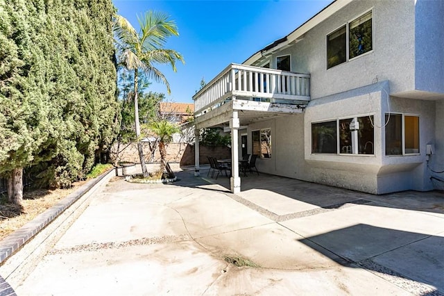 back of house featuring stucco siding, a patio, and fence