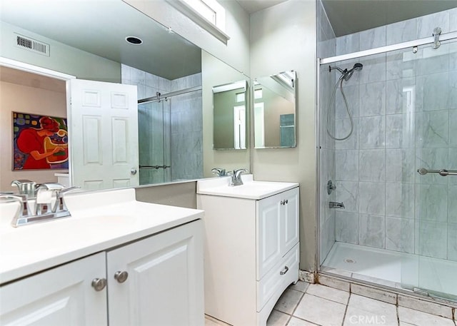 full bathroom featuring a stall shower, visible vents, and a sink