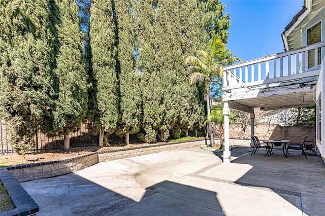 view of patio with outdoor dining space and fence