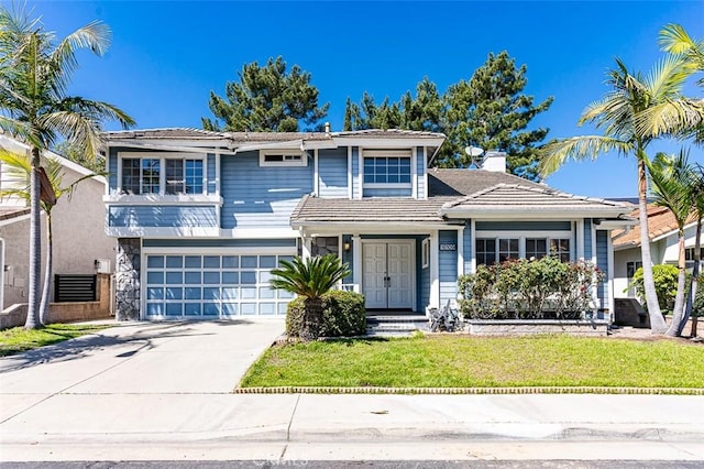 view of front of property featuring driveway, a tile roof, a front yard, an attached garage, and a chimney