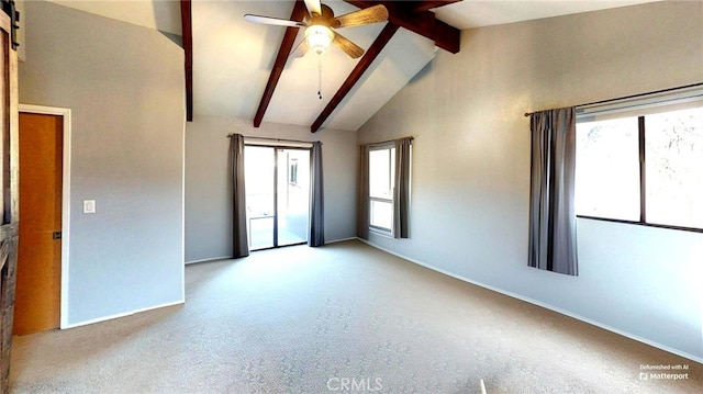 spare room featuring baseboards, ceiling fan, vaulted ceiling with beams, and carpet