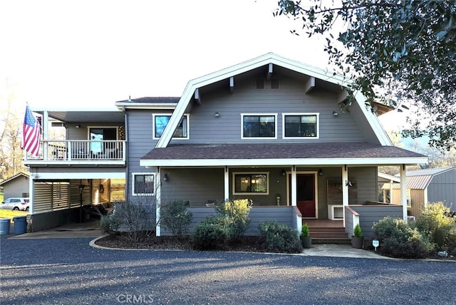 view of front facade with a porch and a shingled roof