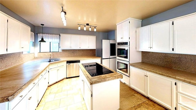 kitchen featuring a center island, backsplash, white cabinetry, and stainless steel appliances