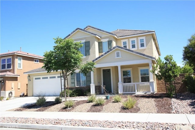 view of front of property with concrete driveway, a garage, covered porch, and stucco siding