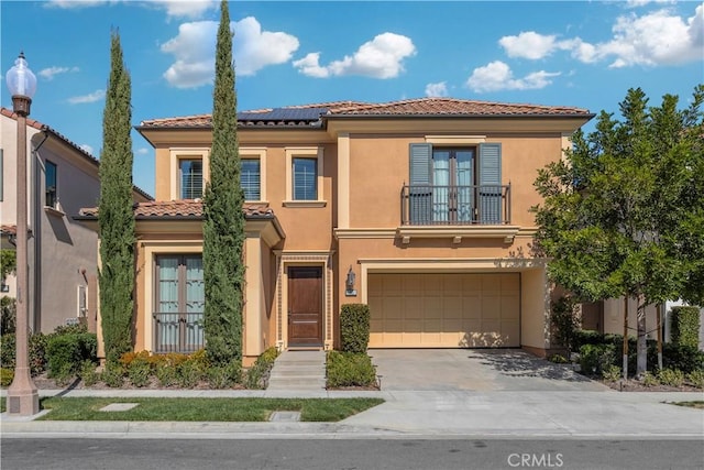 mediterranean / spanish-style house with a balcony, french doors, and stucco siding