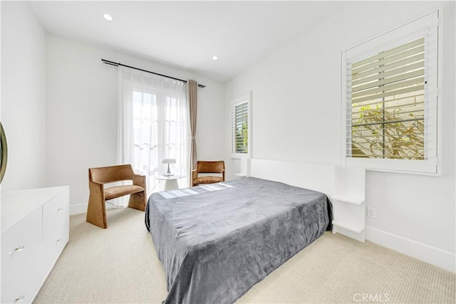 bedroom with recessed lighting, light colored carpet, and baseboards