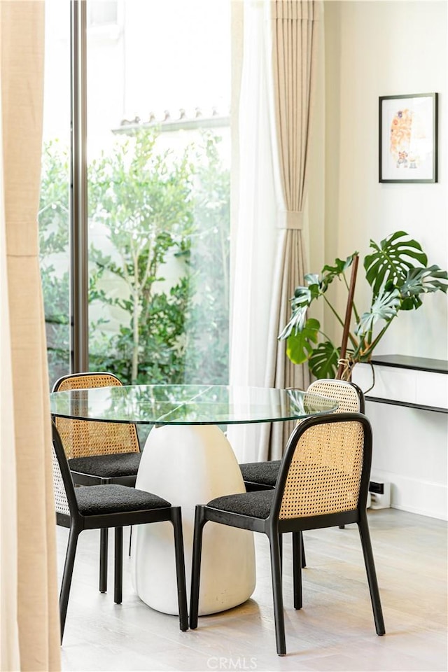 dining room with plenty of natural light and wood finished floors