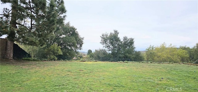 view of yard featuring a rural view and fence