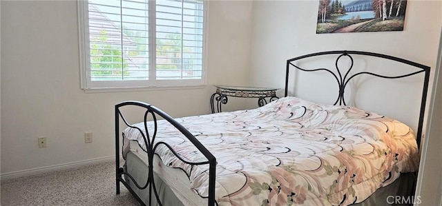 bedroom with carpet flooring and baseboards