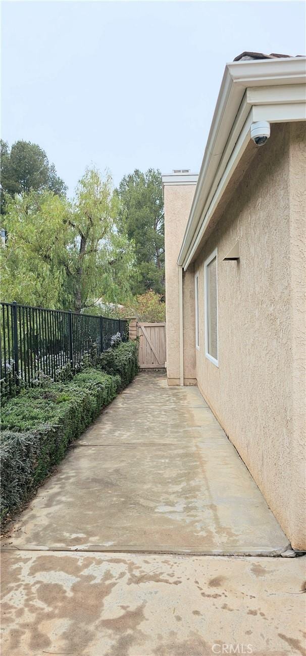 view of patio with a gate and fence