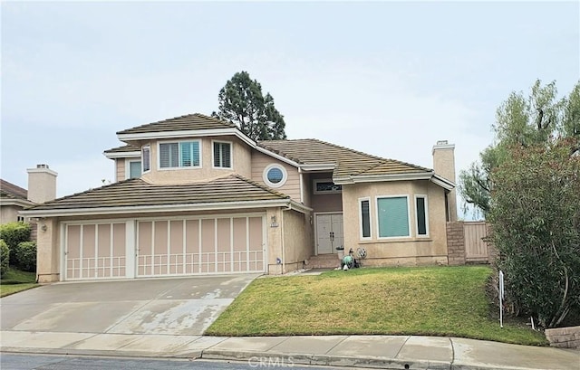 view of front of house featuring fence, a tile roof, concrete driveway, a front yard, and a chimney