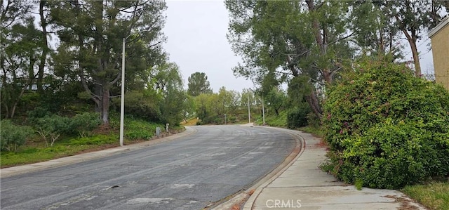 view of road with curbs and sidewalks