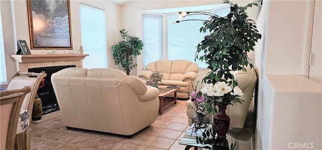 living room featuring light tile patterned floors and a fireplace