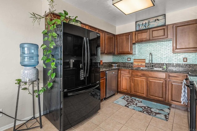 kitchen featuring a sink, brown cabinets, tasteful backsplash, and black appliances