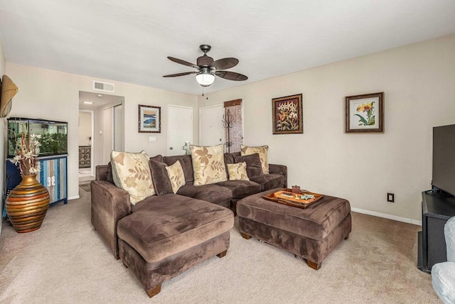 living room with visible vents, baseboards, ceiling fan, and carpet flooring