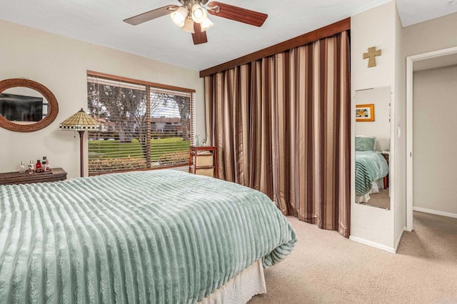 bedroom with ceiling fan, baseboards, and carpet floors