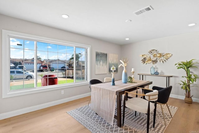 office space featuring recessed lighting, visible vents, baseboards, and light wood-style flooring