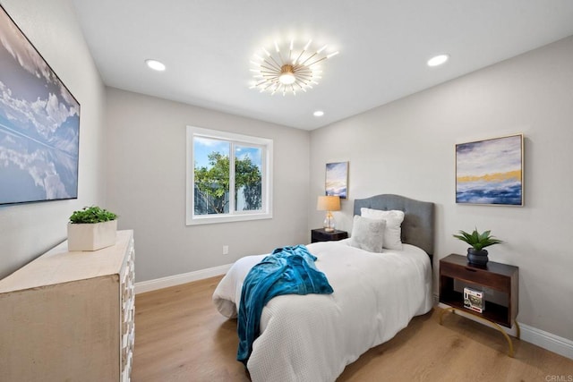 bedroom with recessed lighting, light wood-type flooring, and baseboards