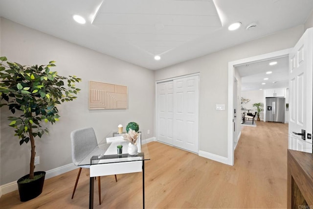 office space featuring recessed lighting, light wood-type flooring, and baseboards