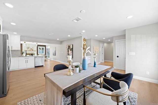 office space with recessed lighting, visible vents, baseboards, and light wood finished floors