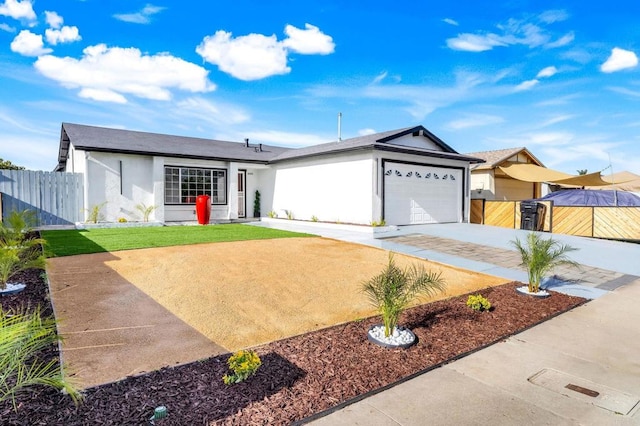 ranch-style house featuring a front yard, fence, an attached garage, stucco siding, and concrete driveway