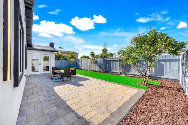 view of patio / terrace with french doors and a fenced backyard