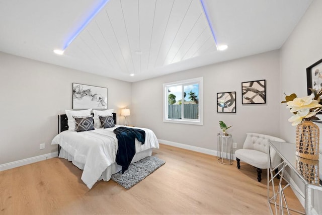 bedroom with recessed lighting, wooden ceiling, light wood-type flooring, and baseboards