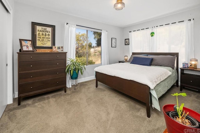 bedroom with carpet flooring and baseboards