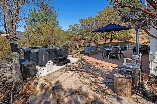 view of patio with outdoor dining space and a hot tub