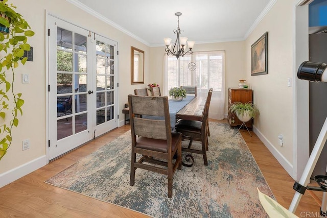 dining room with wood finished floors, baseboards, french doors, and ornamental molding