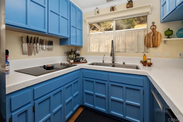 kitchen with black electric stovetop, tile countertops, ornamental molding, blue cabinets, and a sink