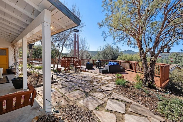 view of patio with a deck with mountain view and an outdoor hangout area