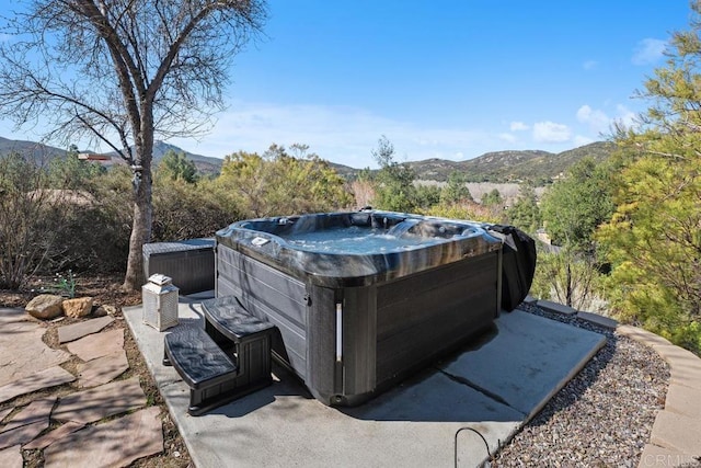 view of yard with a mountain view and a hot tub