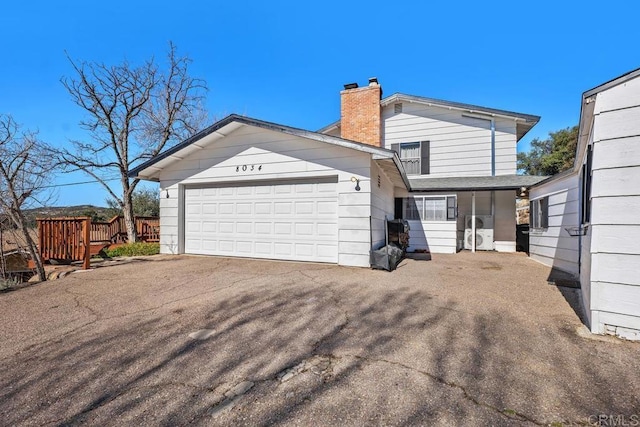 exterior space featuring a chimney and a garage