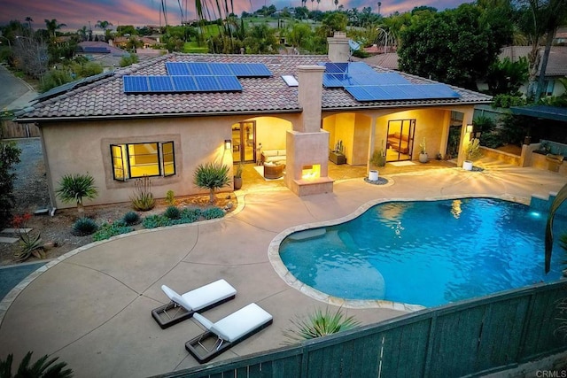 view of swimming pool featuring fence, a patio area, a fenced in pool, and a fire pit