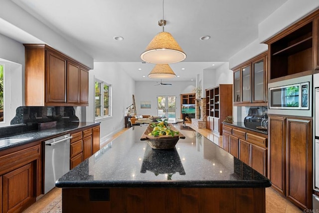 kitchen with backsplash, stainless steel appliances, open shelves, and a kitchen island