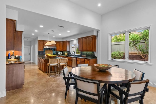 dining space featuring baseboards, plenty of natural light, and visible vents