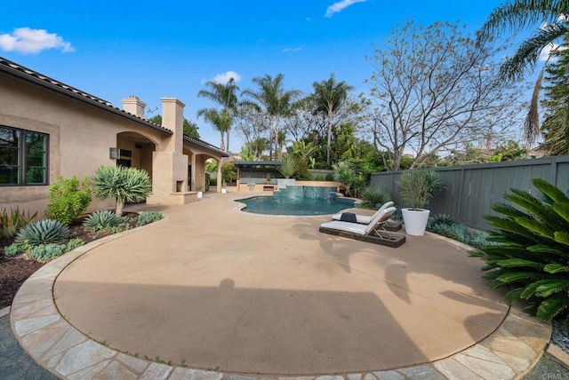 view of swimming pool featuring a fenced in pool, a fenced backyard, and a patio