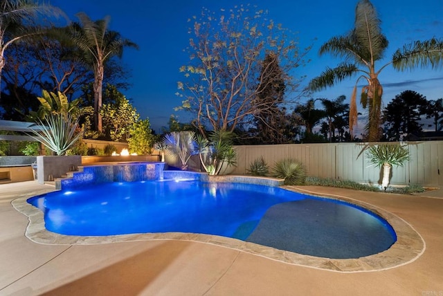 pool at twilight with a fenced in pool and a fenced backyard